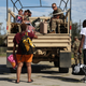 Louisiana National GuardSpc. Jude Urrada prepares to help evacuees onto the truck after Hurricane Laura passed through the area on August 27, 2020, in Lake Charles, Louisiana.